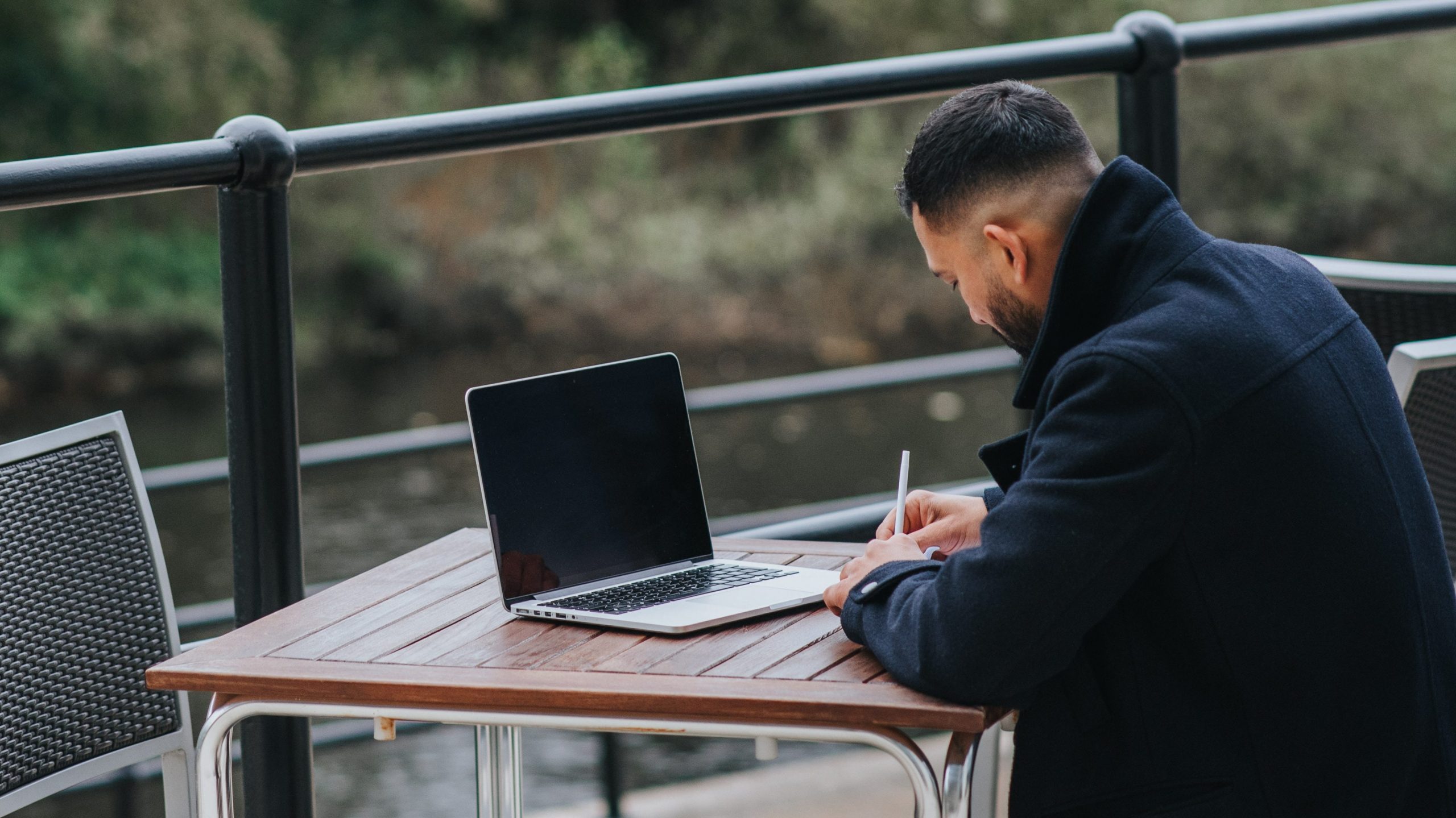 man working on laptop outside