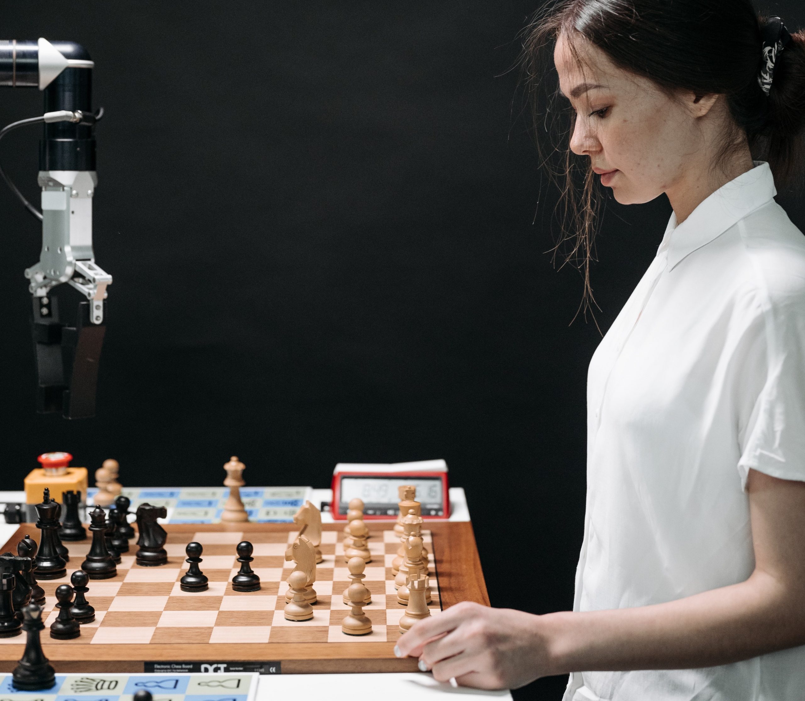 woman playing chess against machine